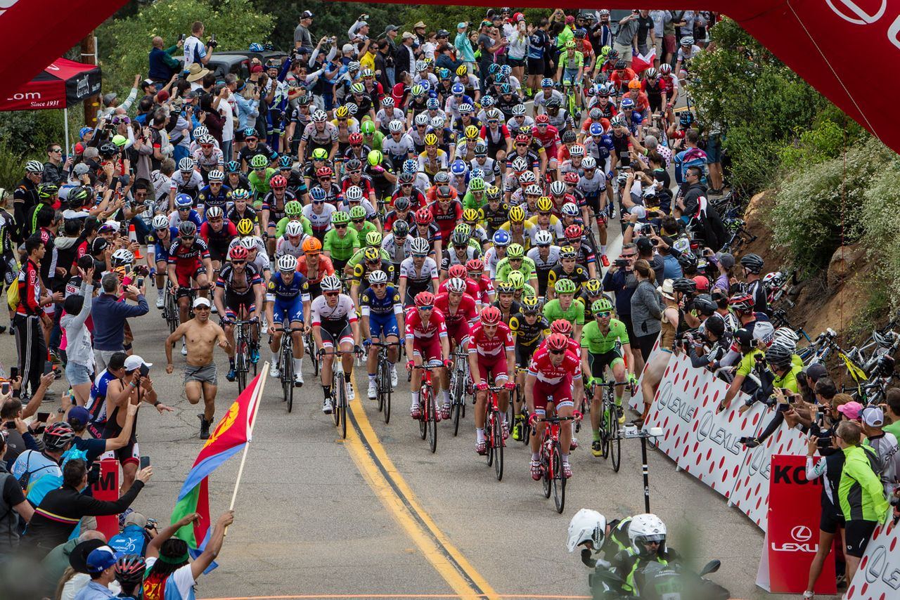 The main field hits the top of the climb