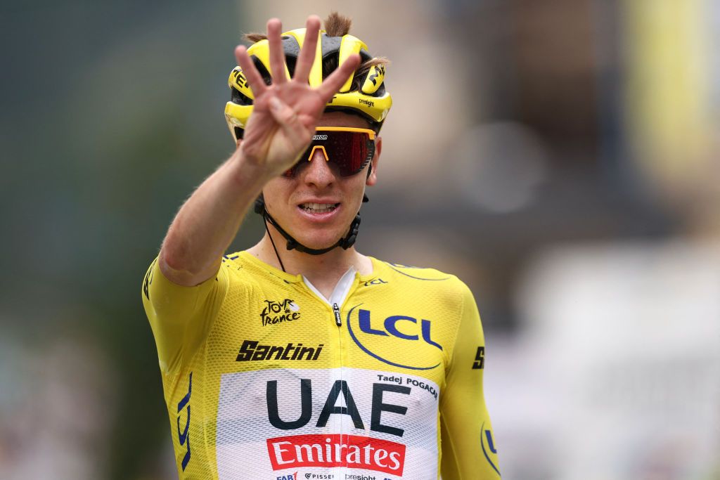 Tour de France leader Tadej Pogacar celebrates as he crosses the finish line to win stage 19