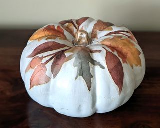 Easy no-carve pumpkin ideas with decoupaged leaf shapes on a white pumpkin