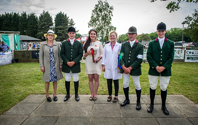 Lizzie Pinney, director of the Association of the Masters of Harriers and Beagles awards a cup to representatives of the RAC Beagles