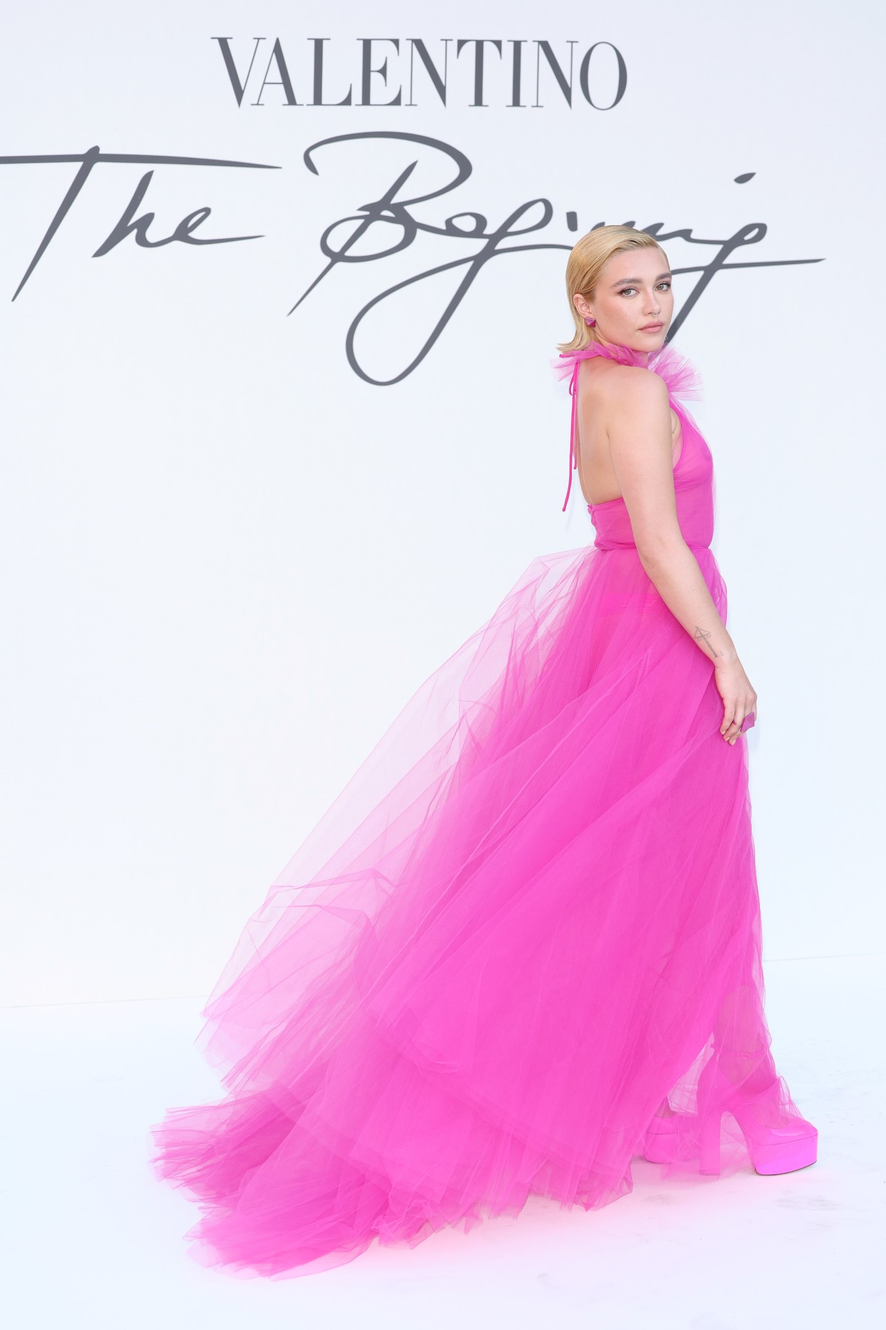 Florence Pugh is seen arriving at the Valentino Haute Couture Fall/Winter 22/23 fashion show on July 08, 2022 in Rome, Italy in a bright pink sheer dress.