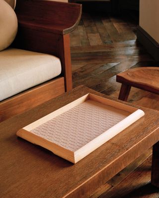 Wooden tray by Pierre Yovanovitch photographed on a table