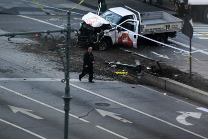 Investigators inspect the truck that struck pedestrians in NYC
