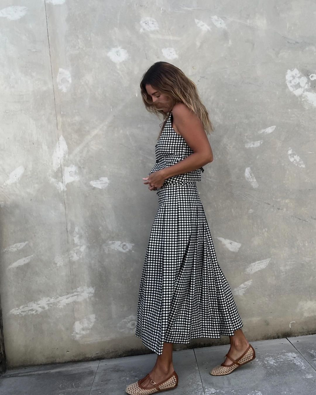 Elegant Summer Style: @angiesmithstyle wears a gingham waistcoat and matching midi skirt