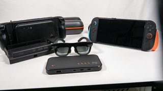 A Nintendo Switch 2 and a Steam Deck alongside a Viture Pro Mobile Dock and a pair of Xreal One smart glasses