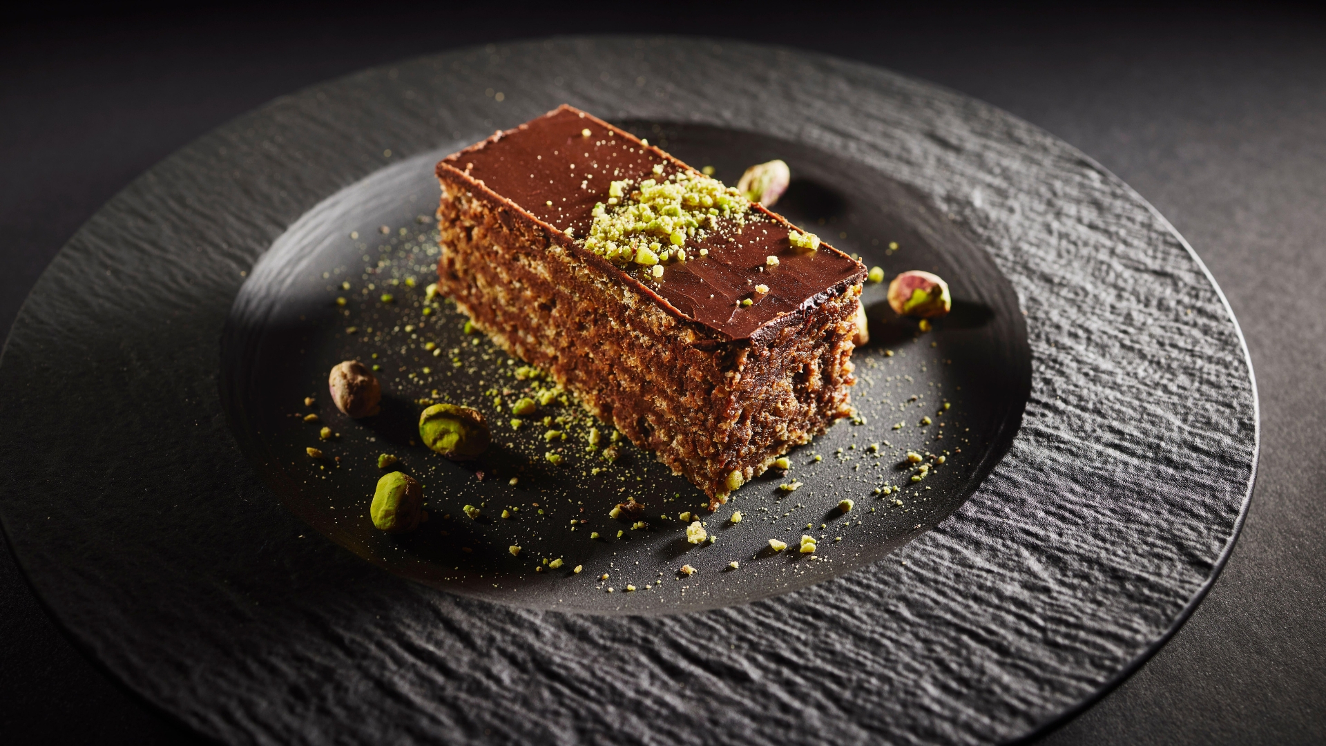 The Bulgarian Garash cake served on a black granite like plate