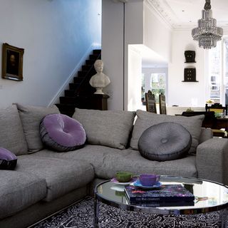living room with white walls and sofa set with cushions
