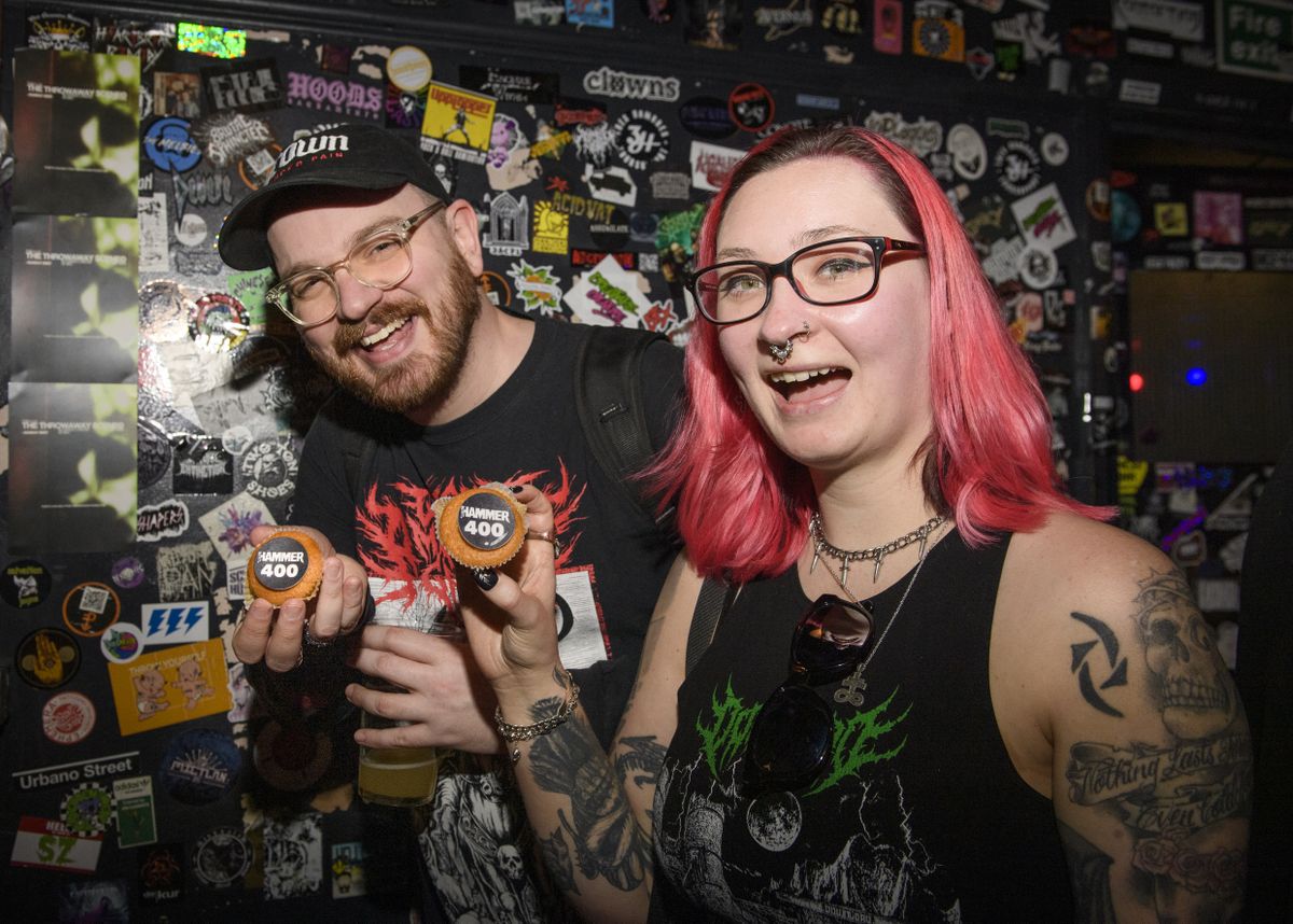 People smiling and throwing the horns