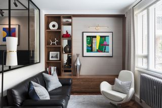 Brown living room with grasscloth wallpaper and colorful abstract art