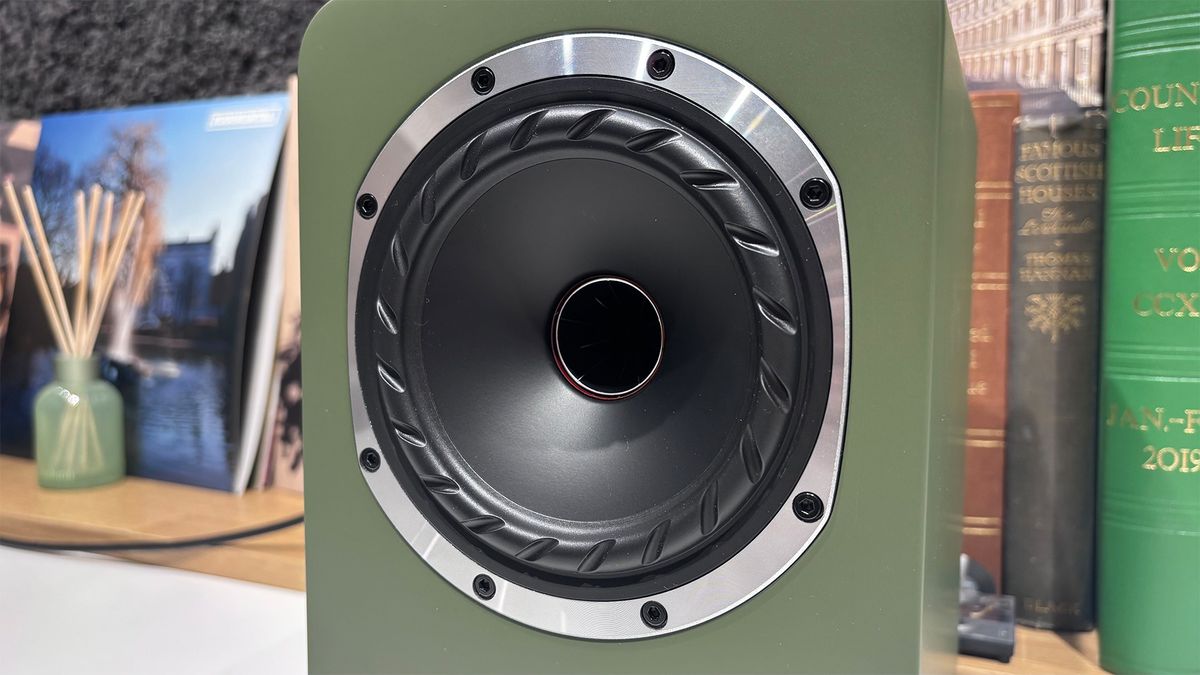 Fyne Audio Cubitt 5 speakers in olive green finish, placed on white table with records in background