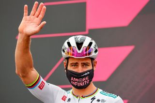 Team BoraHansgrohe rider Slovakias Peter Sagan waves as he poses with riders of his team on stage prior to the start of the second stage of the Giro dItalia 2021 cycling race 179 km between Stupinigi and Novara on May 9 2021 Photo by Luca Bettini AFP Photo by LUCA BETTINIAFP via Getty Images