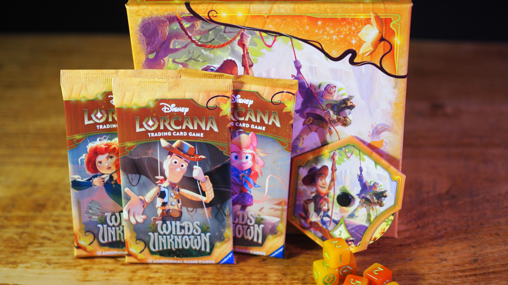 Disney Lorcana boosters, box, Lore spinner, and dice on a wooden surface