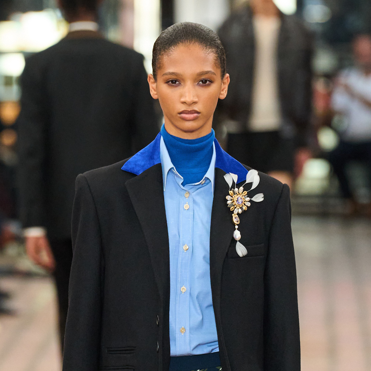 A model wearing a Wales Bonner brooch. 