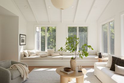 white living room with window bench