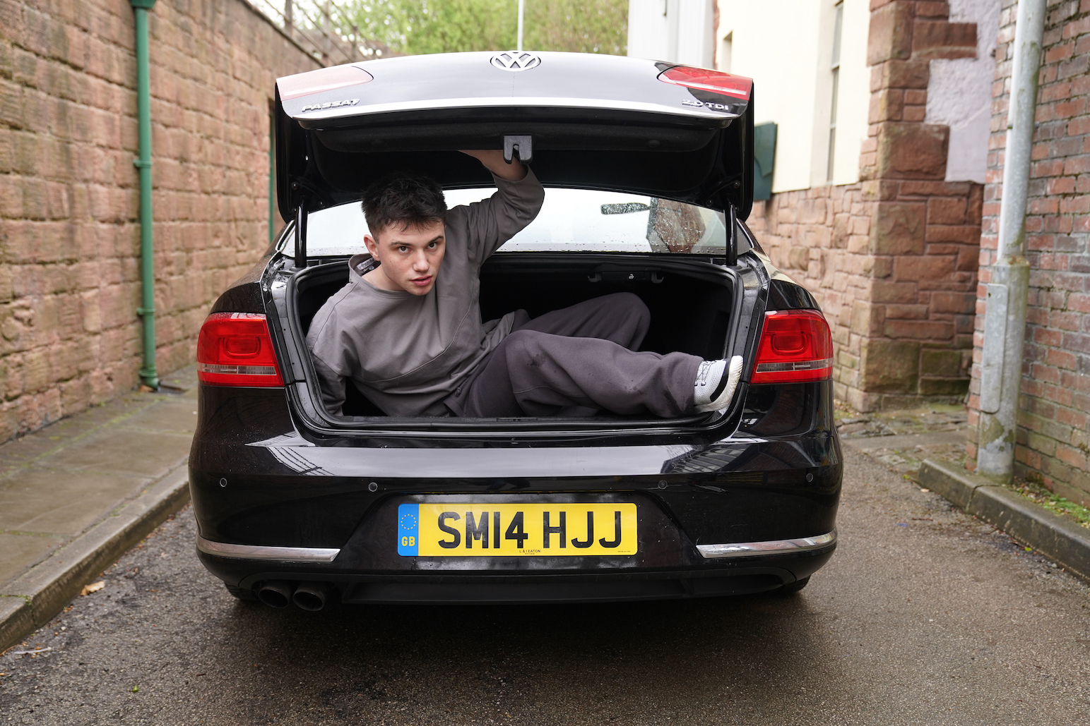 Bobby Costello escaping in the back of a car.