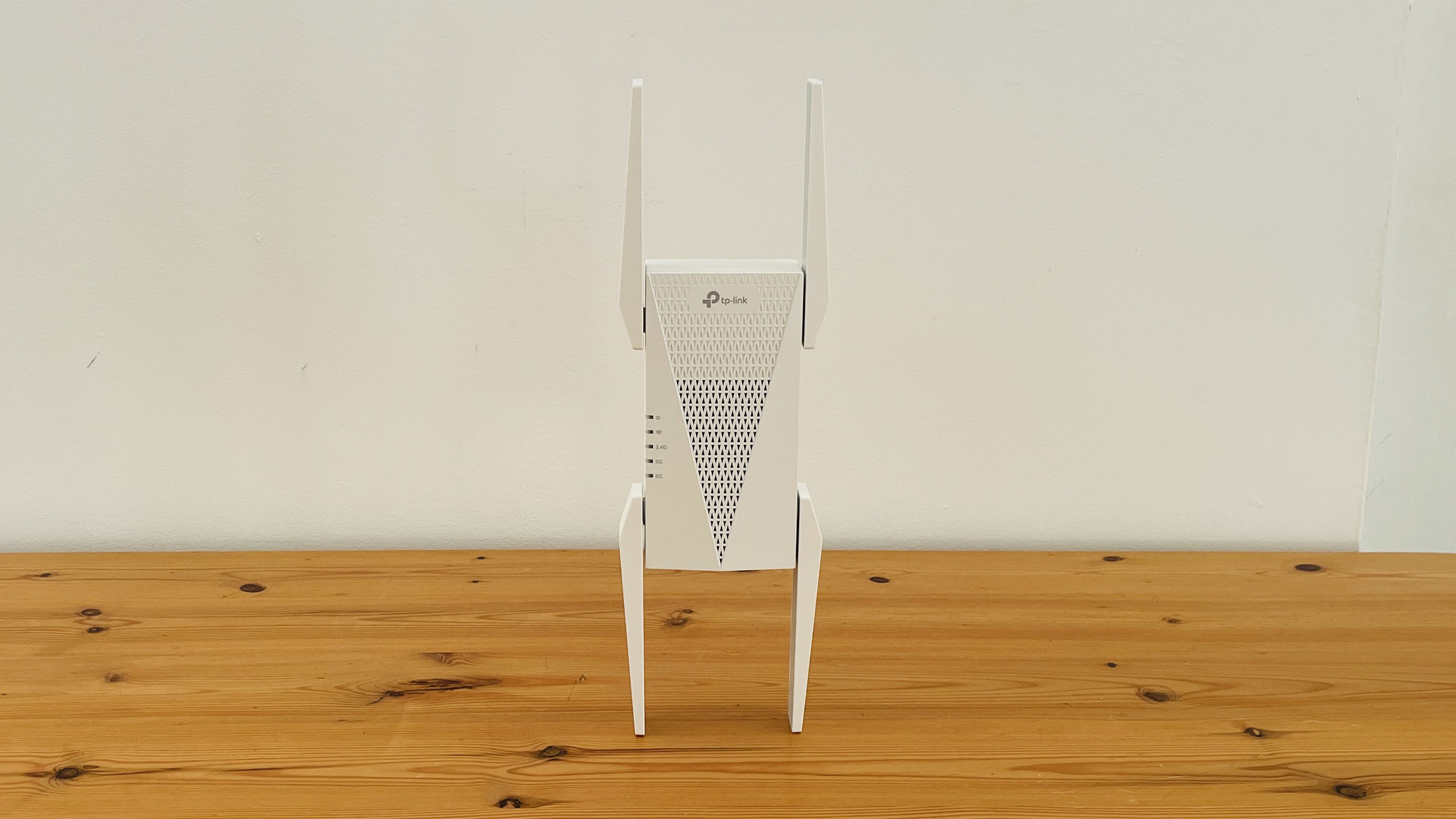 TP-Link AXE5400 range extender on wooden table