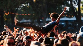 A man crowdsurfs at Aftershock festival