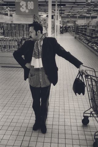 photo of man with trolley in supermarket
