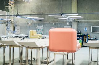 Pink modular chair seen from the back in a factory