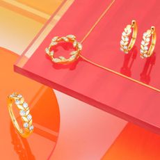 A selection of Goldsmiths jewellery on a pink and orange background