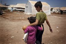 Syrian refugee children walk in the Bab al-Salam refugee camp in Syria's northern city of Azaz on July 15, 2013. Five thousand people a month are dying in the Syria war which has now thrown u