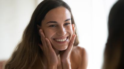 Smiling model looking into mirror