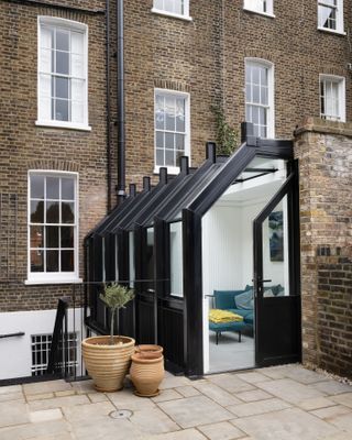 small side extension made of glass and timber to terrace house