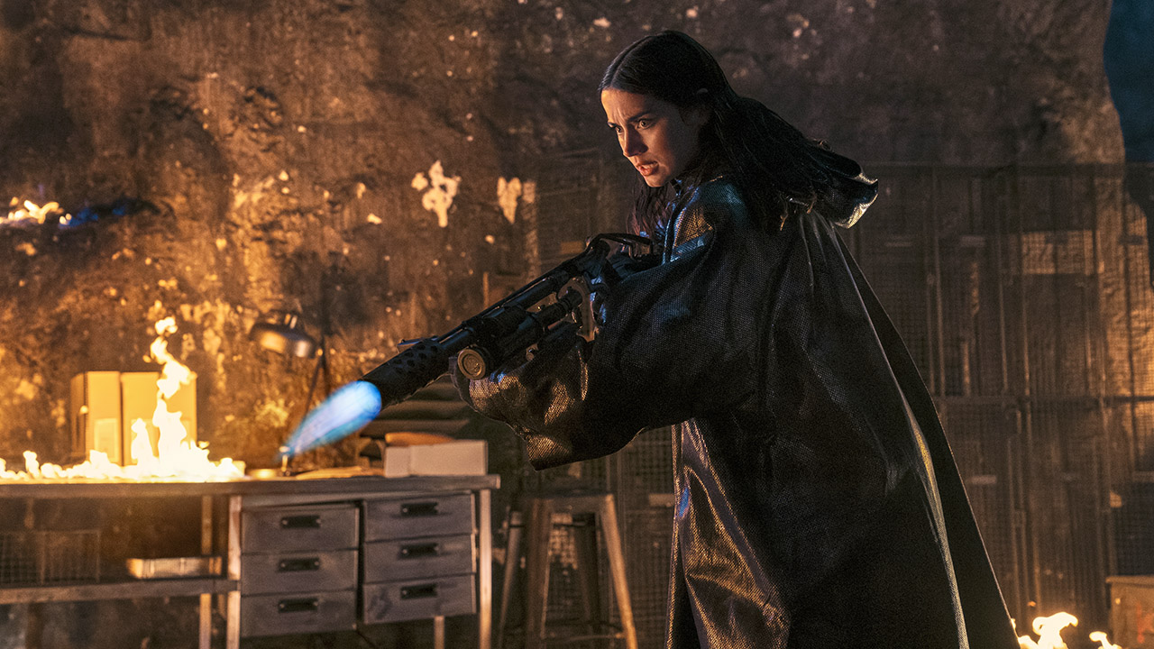 Eve Macarro holding a flamethrower at night in John Wick movie Ballerina