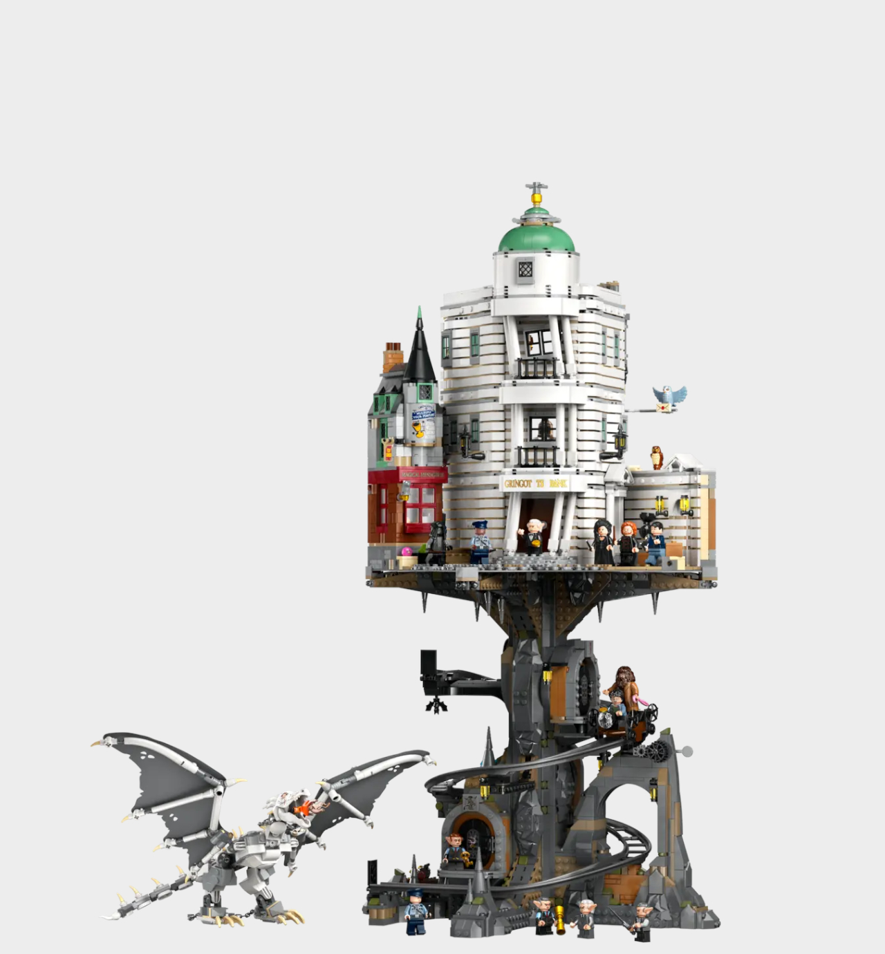 Lego Gringotts Wizarding Bank set, minifigures, and dragon model against a plain background