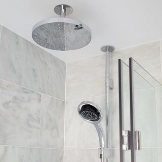 bathroom with grey tiles and shower area