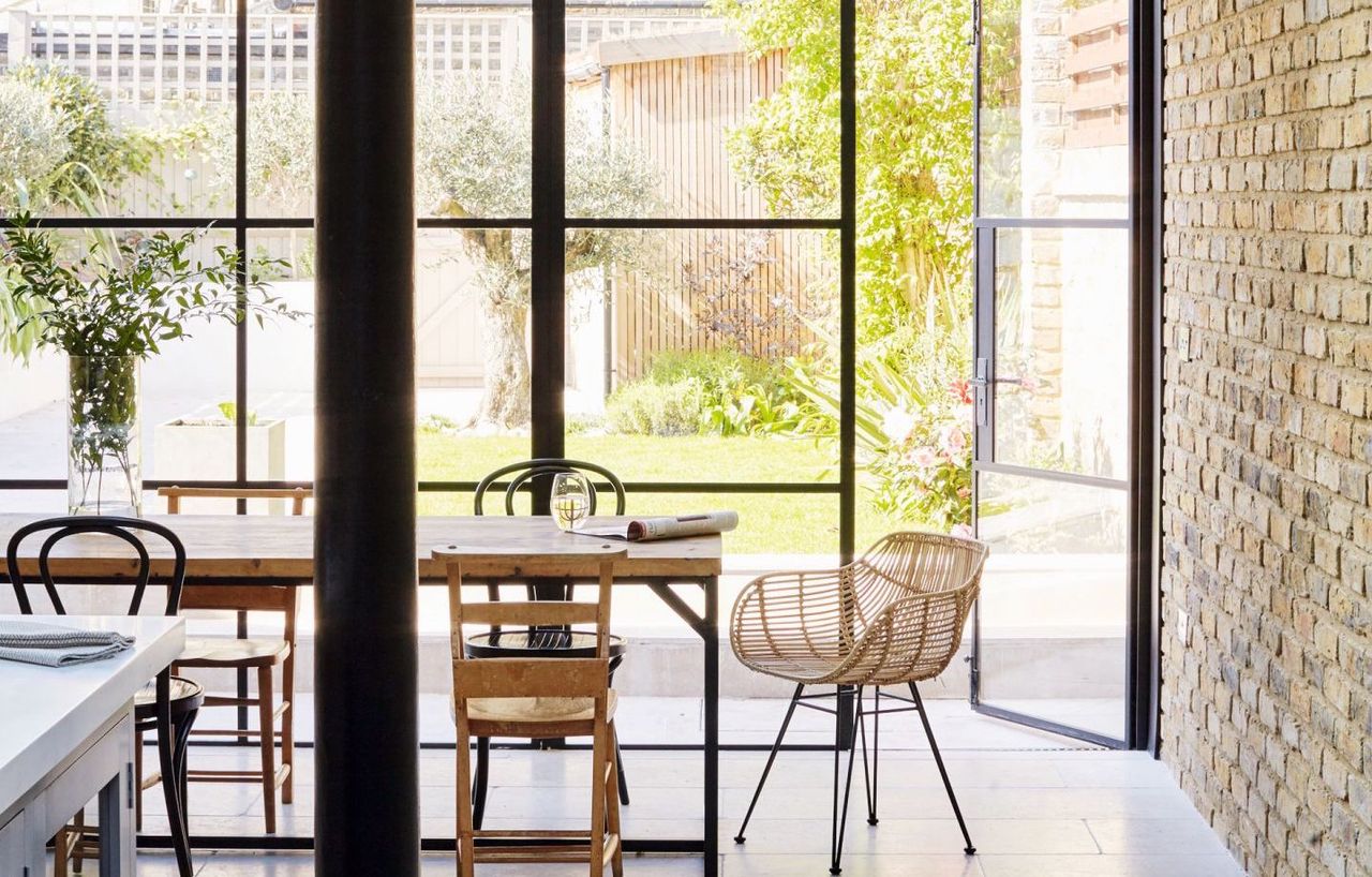 Open plan kitchen diner with an exposed brick wall