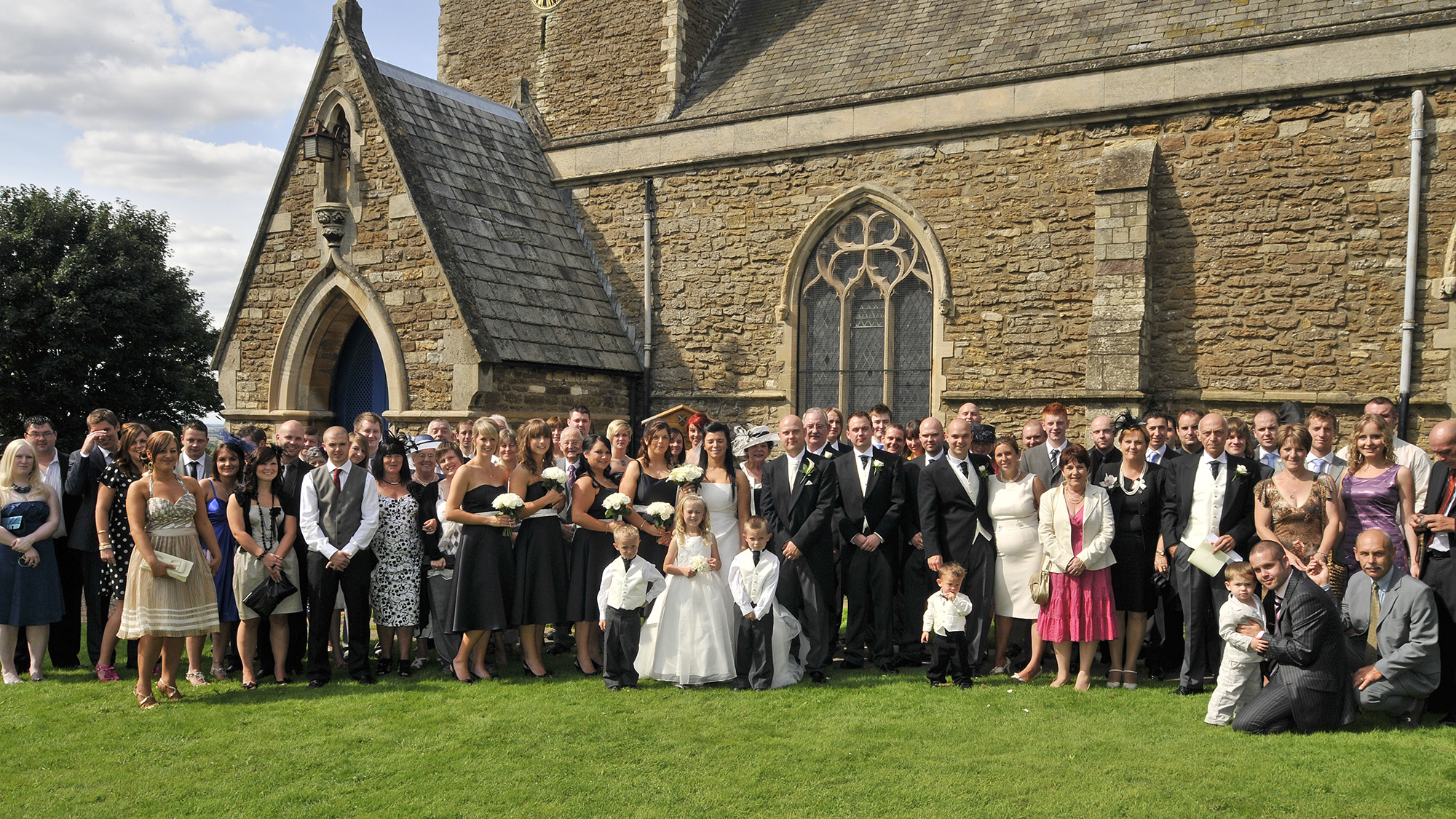Group shot of a wedding party outside the church