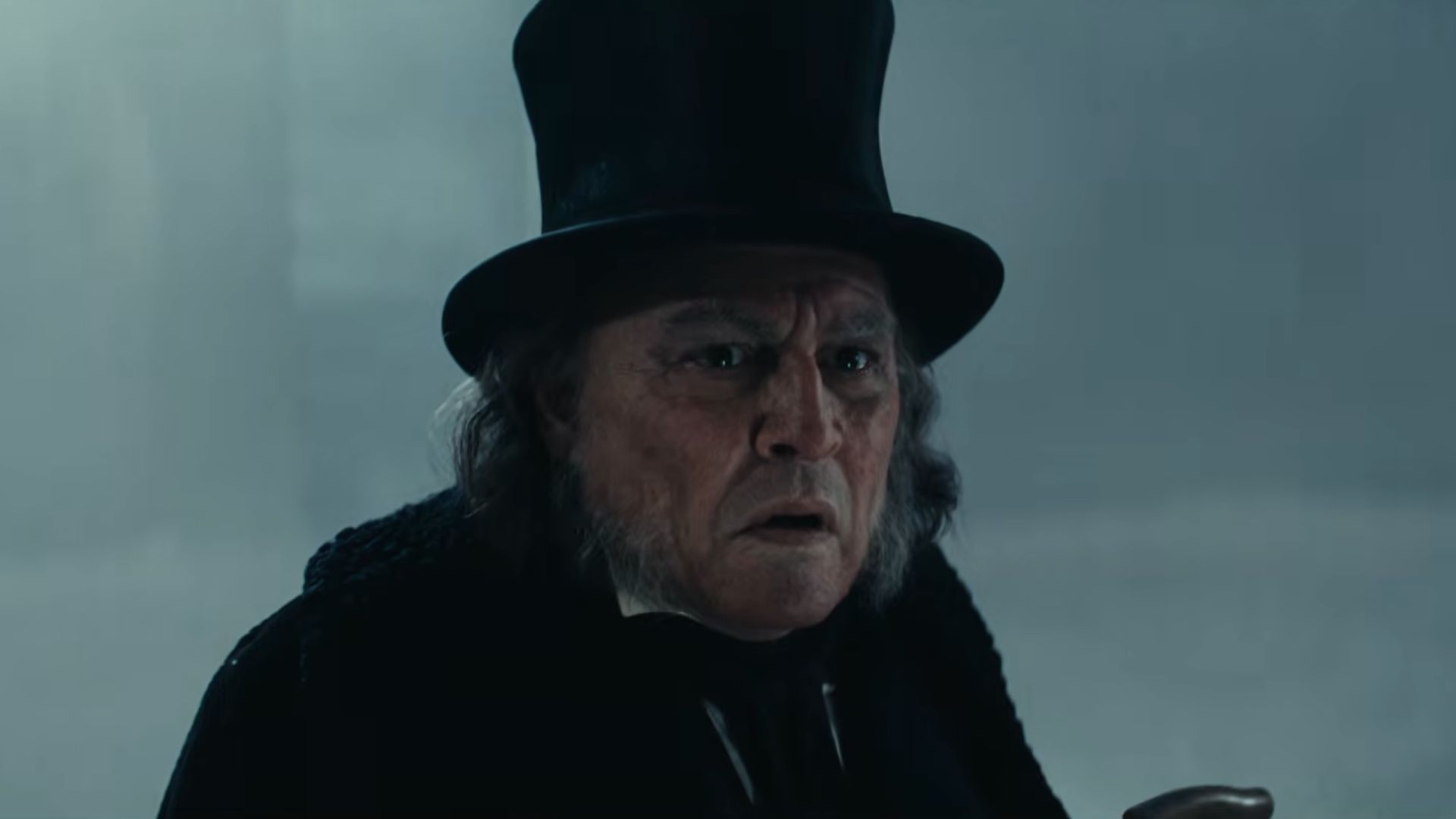 Scrooge looking confused on the street after his door knocker turned into Marley.