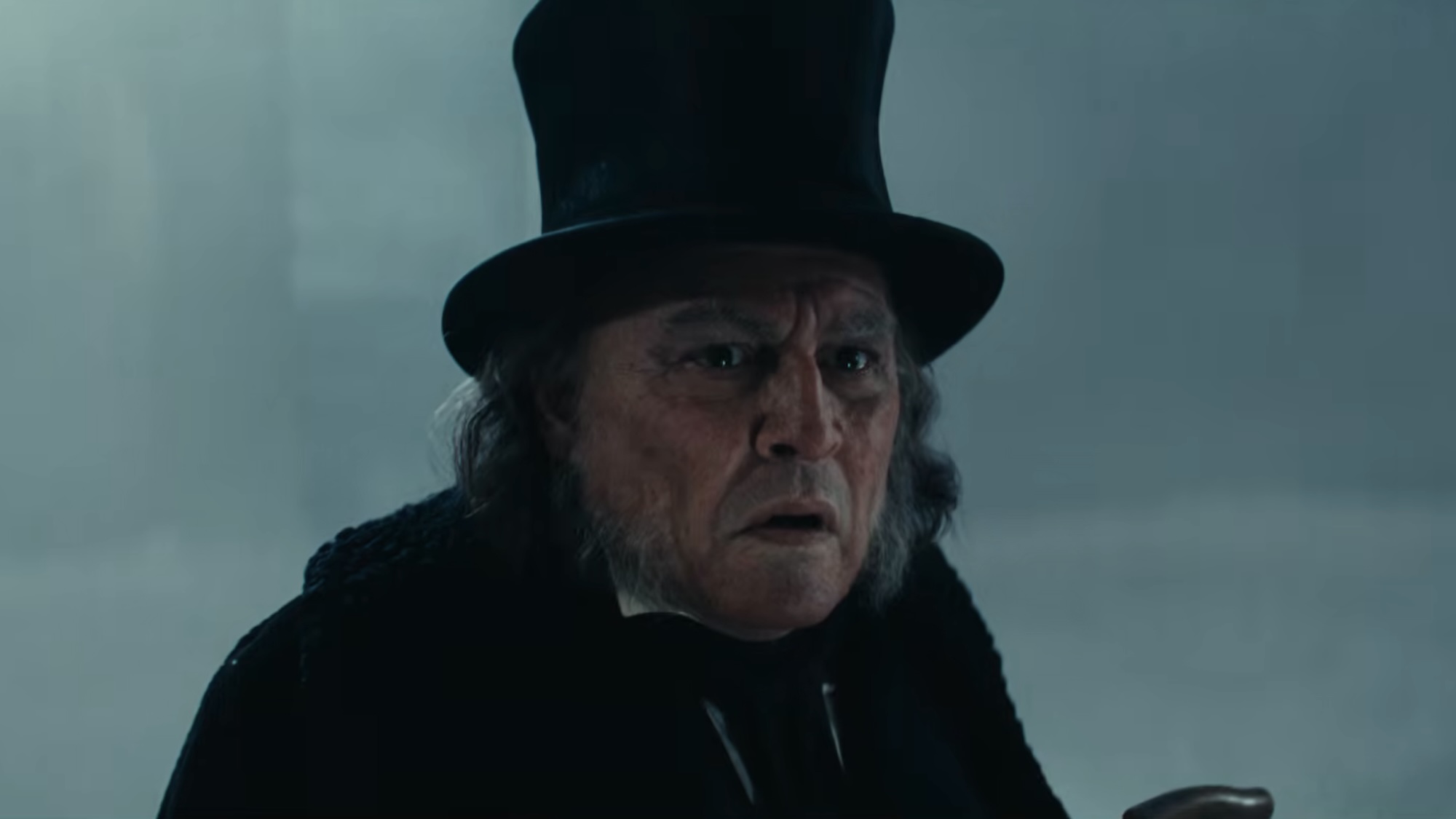Scrooge looking confused on the street after his door knocker turned into Marley.