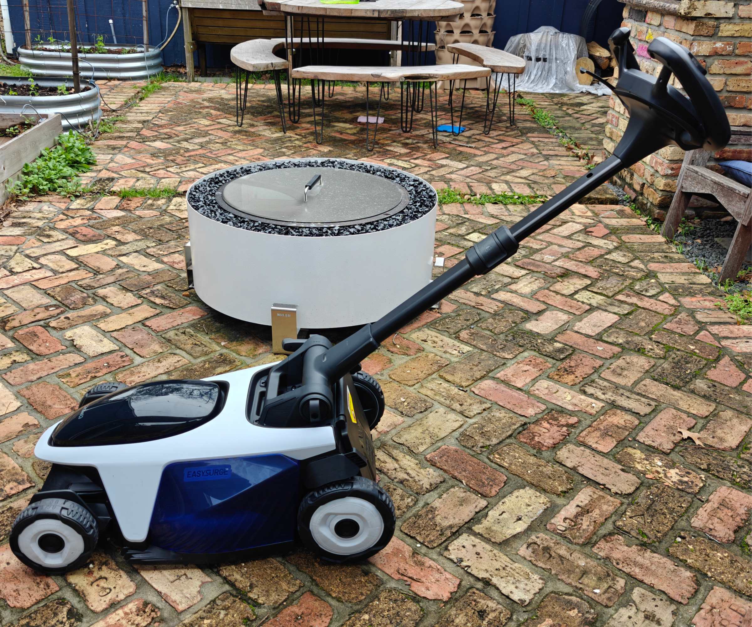 Litheli EasySurge on brick patio in front of white fire pit