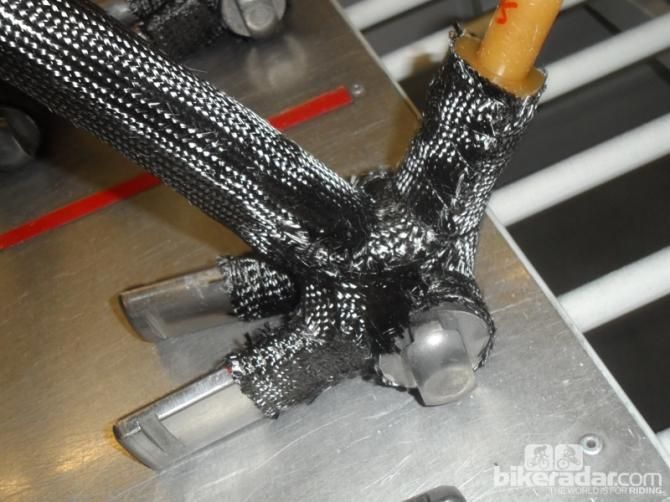 The bottom bracket shell uses 37 layers of woven carbon, all hand-stitched into place