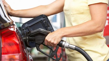 Person filling a car with fuel 