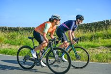 two cyclists ride side by side