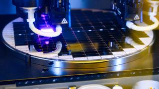 A close up of a processor chip being assembled at a manufacturing plant