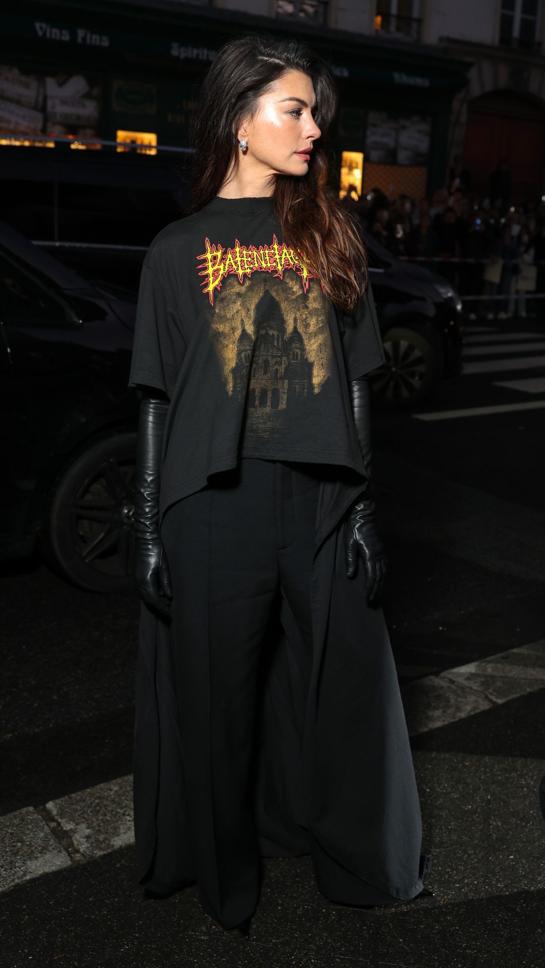Anne Hathaway wearing band tee and suit trousers at Paris Fashion Week, 4 October 2025