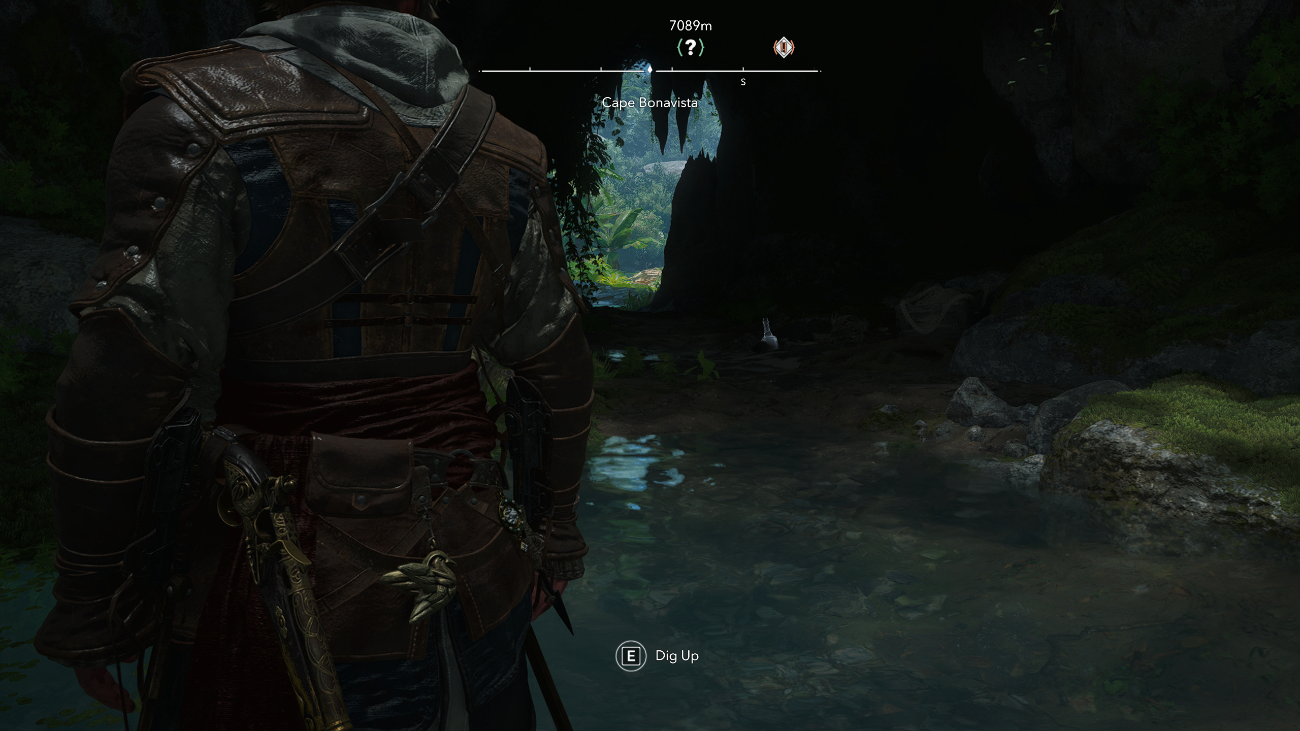 Black Flag treasure maps: Edward standing inside a dark cave looking out at the beach.