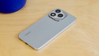 The Honor 400 Lite resting on a wooden table