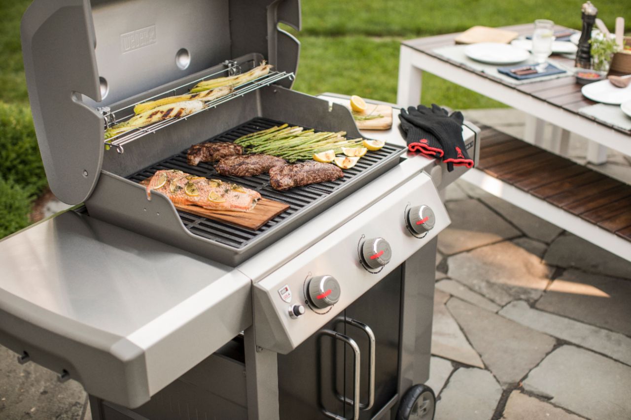 A small three-burner barbecue, one of the safety steps when grilling in a small garden