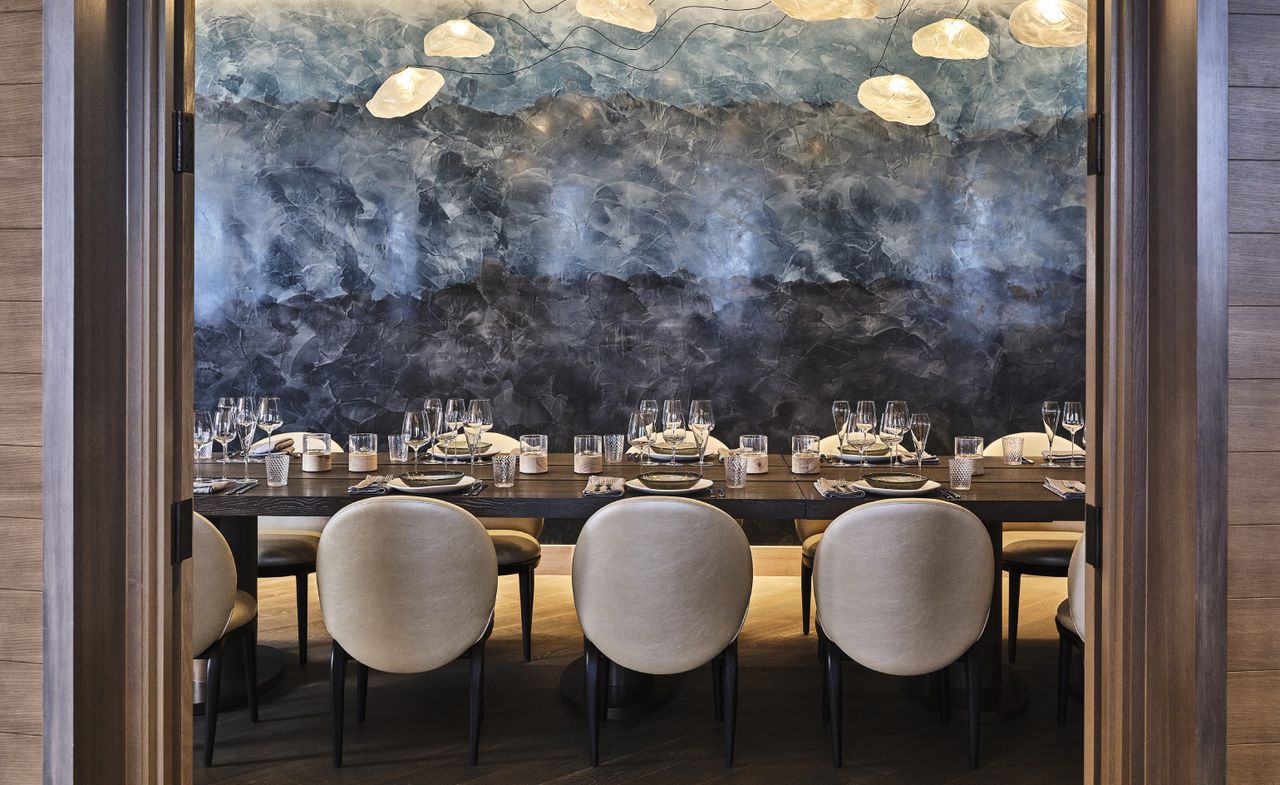 An elegant private dining room with a large blue painting in the wall at The Ritz-Carlton, Portland