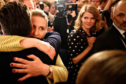 Opposition leader Mette Frederiksen (2L) of The Danish Social Democrats embraces supporters after the election results at Christiansborg Castle in Copenhagen early June 6, 2019, during the co