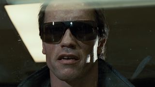 Arnold Schwarzenegger wears dark sunglasses in the iconic movie The Terminator