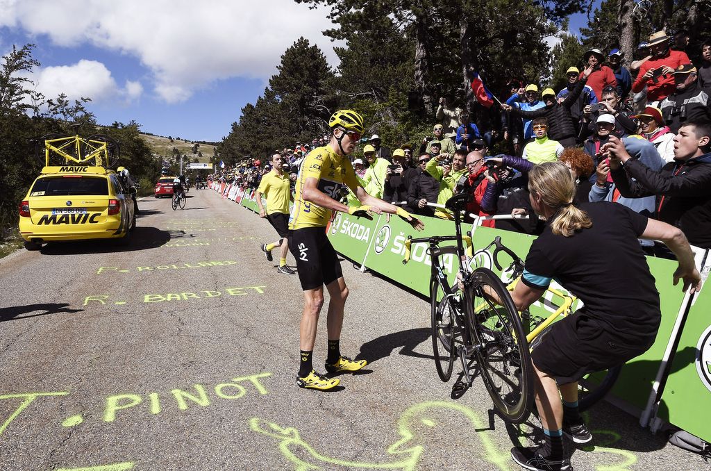 Team Sky's mechanic Gary Blem gets Chris Froome a new bike after the Mont Ventoux incident