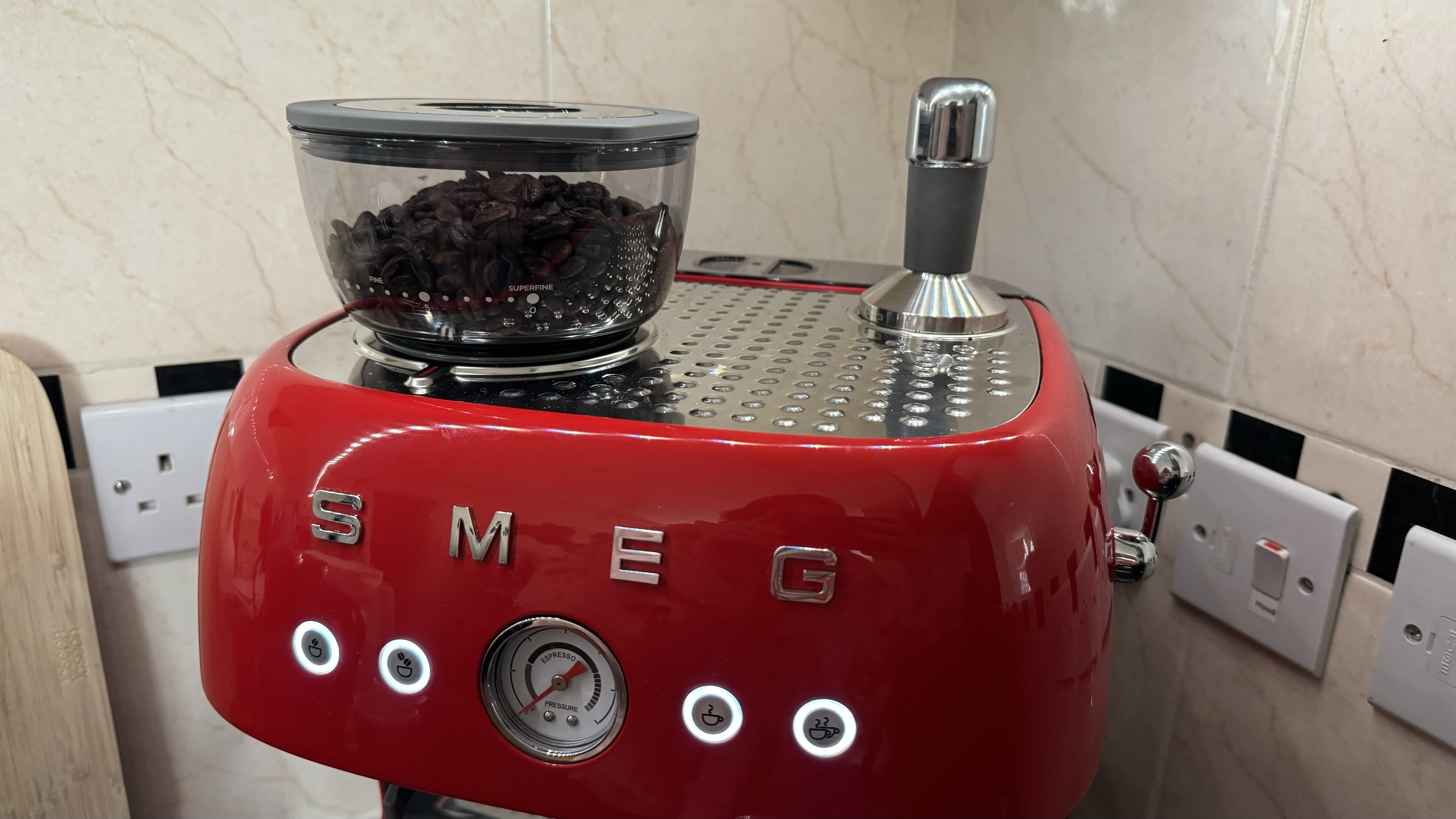 The top of the Smeg Espresso Coffee Machine EGF03, housing the bean hopper and tamp