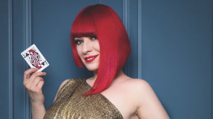 Laura London holding a playing card