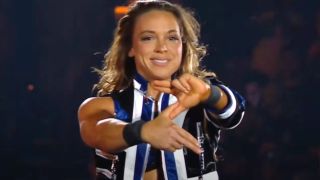Zoey doing her hand logo in the ring before her match